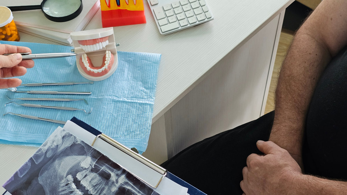 Dental model with X-rays displayed beside tools for treatment planning