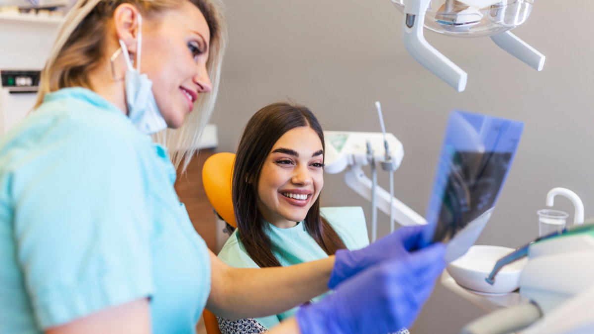 Dentist discussing exam results with patient after dental checkup