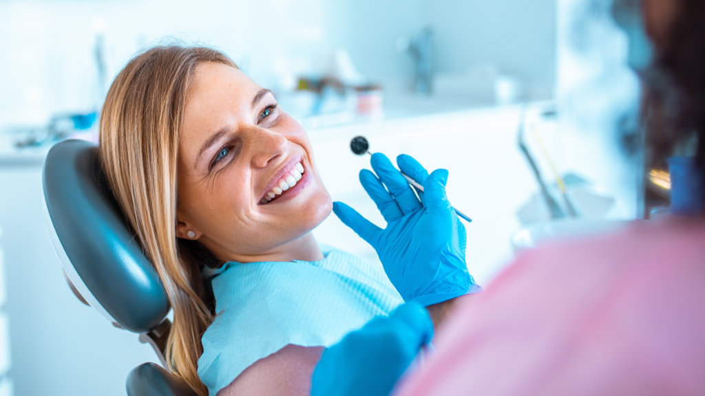 Patient seated in dental chair for routine teeth cleaning visit